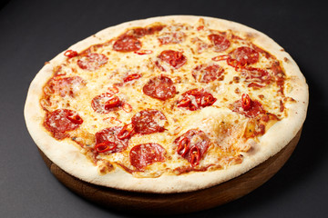 Hot pizza Diablo on a rustic wooden table.