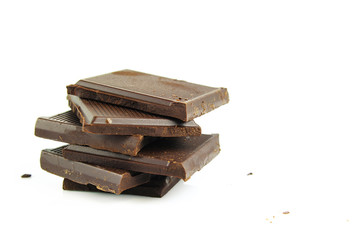 Chocolate cream and chocolate pieces on white background