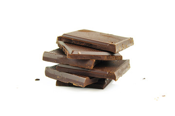 Chocolate cream and chocolate pieces on white background