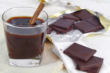 Chocolate cream and chocolate pieces on white background