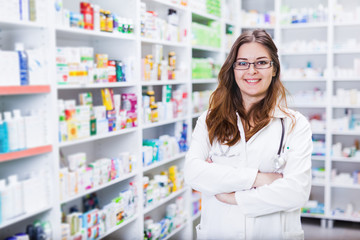 Pharmacist chemist woman standing in pharmacy - drugstore