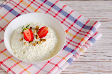 Bowl of cottage cheese with strawberries  and nuts