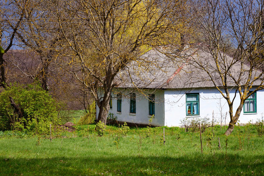 Old traditional ukrainian rural cottage in sunlight of spring