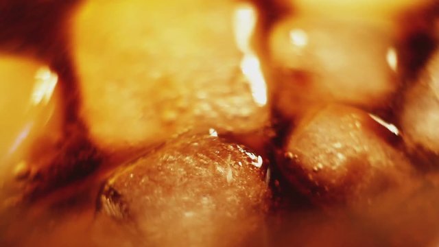 Ice cubes in cola macro