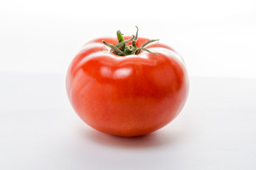Red tomato on a white background.Isolated