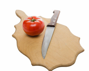 Tomato and knife on the cutting board. Isolated