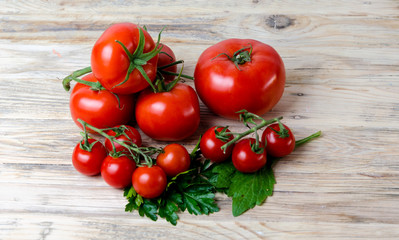 Composition from a tomato on a wooden background.