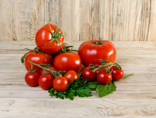Composition from a tomato on a wooden background.