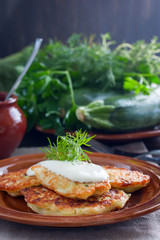 Fritters from zucchini, eggs, flour, salt, ricotta, selective focus