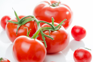 Composition of small cherry and large tomato. Isolated