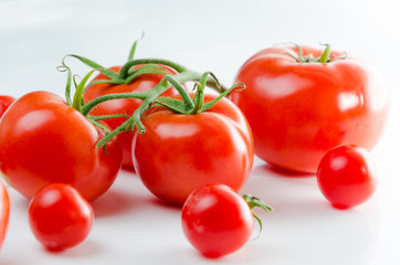 Composition of small cherry and large tomato. Isolated