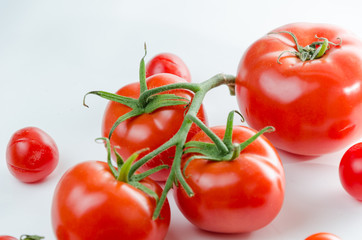 Composition of small cherry and large tomato. Isolated