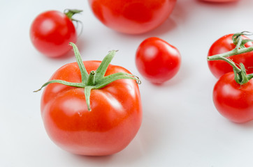 Composition of small cherry and large tomato. Isolated