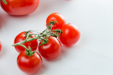 Composition of small cherry and large tomato. Isolated