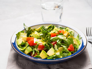 Healthy avocado spinach tomato salad. Gourmet dieting