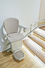 Automatic stair lift on staircase for elderly people.