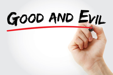 Hand writing Good and evil with marker, concept background