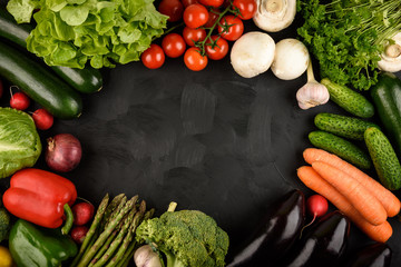 Fresh vegetables as a frame on black background. Copy space.