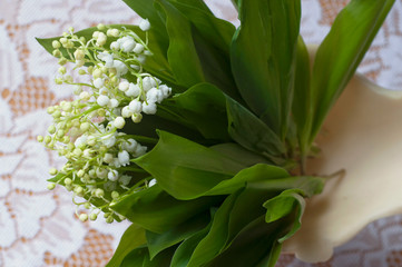 Fototapeta premium Beautiful bouquet of lily of valleys in an elegant vase