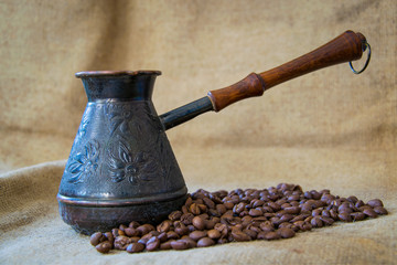 Turkish Coffee Pot, Cezve With Coffee Beans on Sackcloth Background