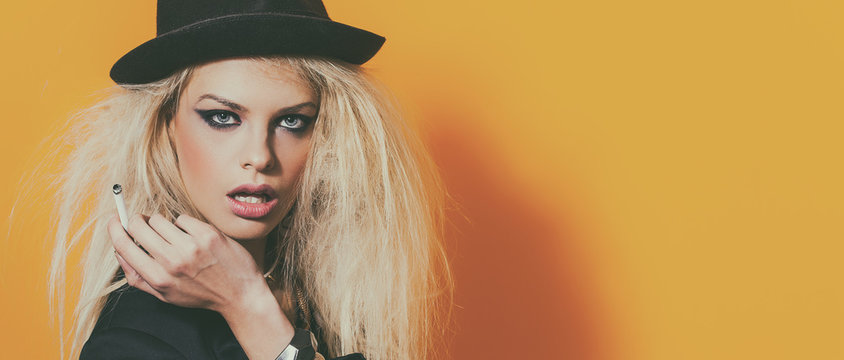 Bohemian beautiful girl wearing blazer and hat while smoking cigarette, letterbox