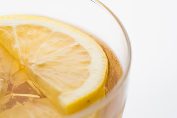 Glass of lemon ice tea isolated on white background. close up