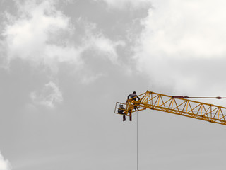 crane workers sitting on steel crane