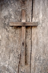 old wooden cross on a wooden background
