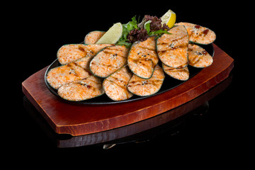 Seafood. Shellfish mussels. Baked mussels with cheese, cilantro and lemon in shells on pan. On a black background with reflection.