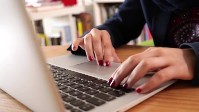 Businesswoman in a modern office working in her laptop. Slow motion video.