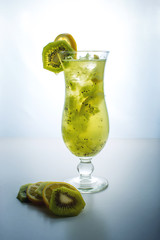 Fruit lemonade in hurricane glass with kiwi and lemon