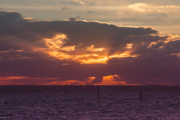 Sunbeams through clouds at sunset