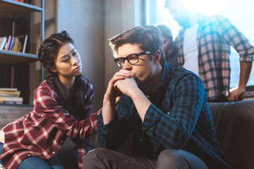 woman supporting male friend