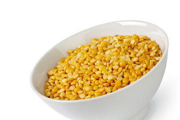 Dry yellow split peas isolated on white.