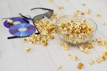 Obraz na płótnie Canvas Popcorn and disks and 3D glasses