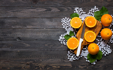 Fresh orange with leaves on wooden background. Top view,