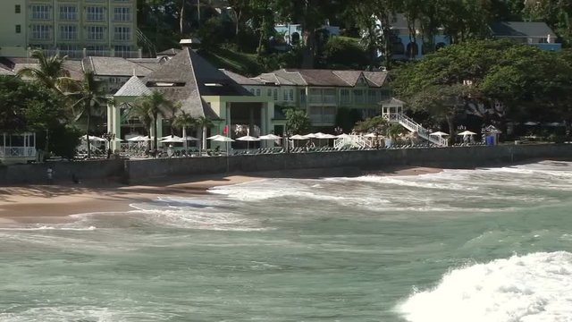 Pan across La Toc beach as waves crash ashore in St Lucia
