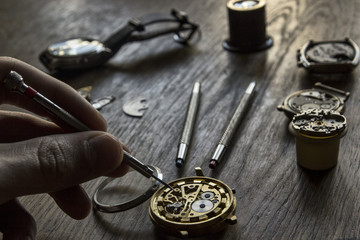 Watchmaker is working in their workshop