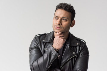 portrait of pensive young african american man isolated on grey