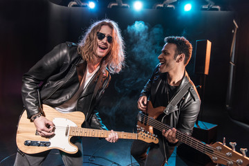 Obraz premium Electric guitar players performing hard rock music on stage