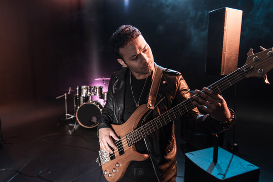 Electric guitar player performing hard rock music with bass guitar on stage