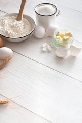 Baking ingredients on rustic wood background