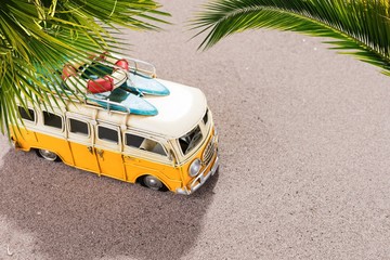 Vintage car with surfboards and rescue ring on the tropical beach
