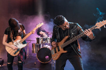 Rock and roll band with electric guitars playing hard rock music on stage