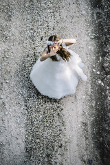 Attractive blond girl in forest dressed in communion