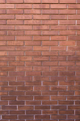 Background of the red brick wall with horizontal masonry, vertical shot