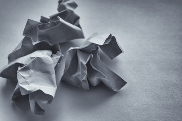 wrinkled green paper on a white table. crumpled notes of failed sketches