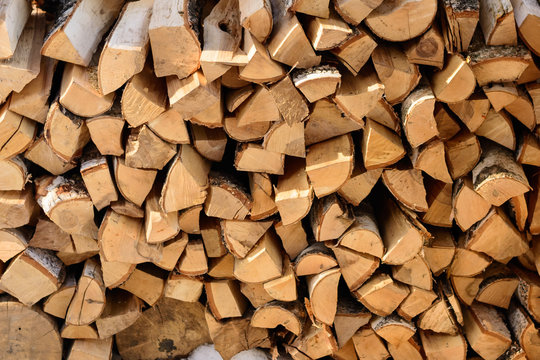 firewood background - split hardwood kiln-dried. split firewood in the stack.