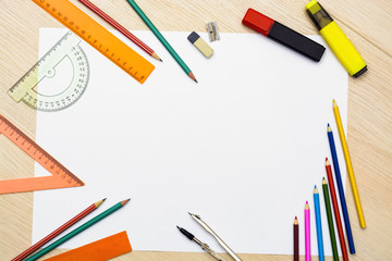 Set of pencils, erasers, post-its and other useful supplies for the school. There is a centered blank sheet for text writing