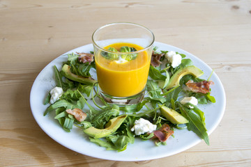 Carrot soup with salad and avocado